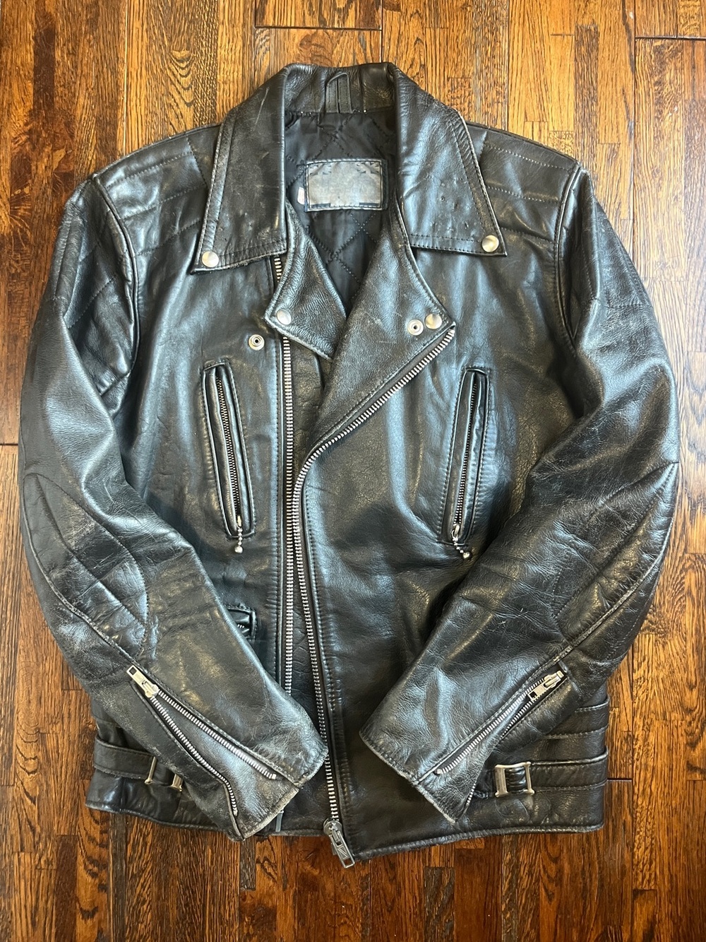 Black vintage leather biker jacket with silver hardware